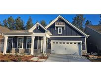 Charming home features a two-car garage, stone accents, and a covered front porch at 2016 Skyhawk Dr, Lake Wylie, SC 29745