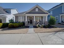 Charming home with a welcoming front porch and beautifully landscaped yard, showcasing its inviting curb appeal at 205 Mac Aly, Cramerton, NC 28032