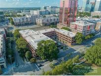 An aerial view of a charming brick building surrounded by lush trees in the heart of the city at 310 Arlington Ave # Multiple, Charlotte, NC 28203