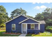 Charming single-story home featuring blue siding, a welcoming front porch, and a well-manicured lawn at 332 Mountain View St, Gastonia, NC 28052