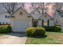Charming single-Gathering home featuring a well-manicured lawn and attached one car garage at 5120 Silabert Ave, Charlotte, NC 28205
