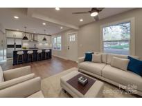 Bright, open-concept living room flows to a modern kitchen with a large island and stylish finishes at 908 Davenport St, Charlotte, NC 28208
