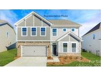 Two-story home featuring gray siding, a brick-lined garage, and a welcoming front porch with stone accents at 149 Saidin Ln, Troutman, NC 28166