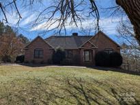 Charming brick home featuring a well-maintained lawn and mature trees at 167 Patterson Rd, Kings Mountain, NC 28086