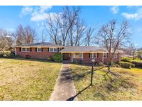 Charming brick home featuring a well-maintained front yard and inviting walkway at 1701 Montclair Ave, Gastonia, NC 28054