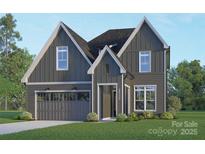 Charming two-story home with gray siding, white trim, garage, manicured lawn, and inviting front entry at 2530 Elkwood Cir, Charlotte, NC 28205