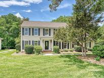 Charming two-story home with black shutters and a well-manicured lawn on a sunny day at 3600 Carmel Rd, Charlotte, NC 28226