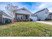 Charming home with a well-manicured lawn and inviting front porch showcasing its delightful curb appeal at 3624 County Down Ave # 5-14, Kannapolis, NC 28081
