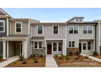 Inviting townhouse showcasing stone accents, gray siding and a well manicured landscape at 4117 Walking Ridge Rd # 55, Charlotte, NC 28208