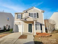 Charming two-story home with a well-maintained front yard and attached garage at 8353 Ainsworth St, Charlotte, NC 28216