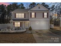 Charming two-story home featuring manicured landscaping, a two-car garage, and inviting curb appeal at 10816 Pointer Ridge Dr, Charlotte, NC 28214