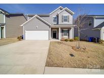 Charming two-story home with gray siding, a two-car garage, and well-manicured lawn, creating great curb appeal at 109 Fosters Glen Pl, Mooresville, NC 28115