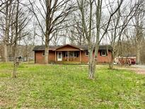 Charming brick home featuring a cozy front porch and spacious front yard at 122 Wesley Woods Rd, Monroe, NC 28110