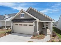 Charming gray home featuring a two-car garage and landscaped front yard at 1615 Shoals Ave # 158, Belmont, NC 28012