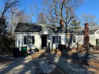 Charming one-story home featuring a classic design, inviting entrance, and a well-manicured lawn at 2404 Booker Ave, Charlotte, NC 28216