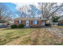 Charming brick home with a well-maintained lawn and covered parking area at 2832 Gail Ave, Gastonia, NC 25052