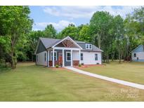 Charming cottage-style home featuring a welcoming front porch and well-manicured lawn at 2853 W Zion Church Rd, Shelby, NC 28150