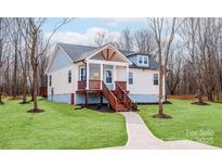 Charming home showcasing a welcoming front porch and manicured lawn at 2855 W Zion Church Rd, Shelby, NC 28150