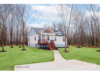 Charming home featuring a well-manicured lawn, inviting porch, and stylish exterior accents at 2855 W Zion Church Rd, Shelby, NC 28150