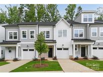 Charming townhome with a well-manicured lawn, neutral color palette, and an attached single car garage at 3158 Finchborough Ct # 256, Charlotte, NC 28269