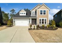 Inviting two-story home featuring a two-car garage and well-maintained landscaping at 416 Clemson Tree Ln, Lake Wylie, SC 29710
