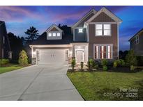 Charming two-story home featuring a two-car garage, landscaped yard, and welcoming front entrance at 416 Clemson Tree Ln, Lake Wylie, SC 29710
