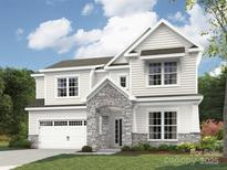 Elegant two-story home featuring stone accents, a two-car garage, and manicured front lawn at 4688 Glen Stripe Dr # Cal0069, Indian Trail, NC 28079