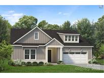 Charming two-story home featuring a welcoming entrance, a two-car garage, and beautifully landscaped front yard at 6005 Valehaven Pl # 0049, Charlotte, NC 28269