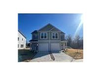 New two-story townhouse with gray siding, attached garage, and freshly poured concrete driveway at 620 Smith St # B, Mooresville, NC 28115