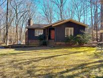 Charming home featuring a brick chimney and beautiful lawn at 8015 Sullivan Dr # 3 And 2, Charlotte, NC 28215