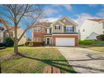 Charming two-story home featuring a brick facade, attached garage, and well-manicured front lawn at 184 Settlers Grove Ln # L7, Salisbury, NC 28146