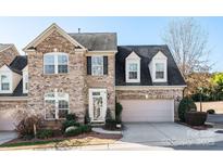 Charming brick two-story house with well-manicured landscaping and a two-car garage at 1910 Colony Line Ct, Charlotte, NC 28210