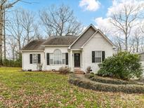 Charming single-story white brick home with manicured front yard and black shutters at 1923 Gables Dr, Monroe, NC 28112