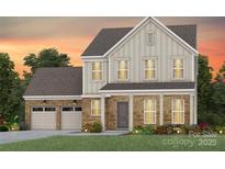 Charming two-story home featuring stone accents, a two-car garage, and manicured landscaping at 2229 Millennium Dr # 014, Lancaster, SC 29720