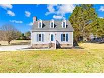 Charming two-story home with dormer windows and blue shutters, set on a well-maintained lawn at 2927 Forest Hills Cir, Rock Hill, SC 29732