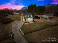 Charming two-story home with dormer windows, a well-manicured lawn, and a long driveway at 2927 Forest Hills Cir, Rock Hill, SC 29732