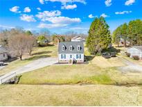 Charming home featuring blue shutters, dormer windows, a manicured lawn, and a long driveway at 2927 Forest Hills Cir, Rock Hill, SC 29732