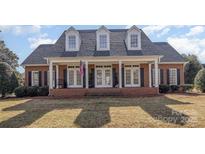 Charming brick home featuring a welcoming front porch with columns and dormer windows at 2968 Robinwood Rd, Gastonia, NC 28054