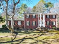 Charming two-story red brick home with classic columns and well-maintained lawn at 3719 Amarillo Sw Dr, Concord, NC 28027