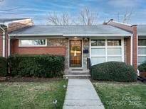 Charming home with stone and brick facade, manicured bushes, and inviting walkway at 4310 Randolph Rd, Charlotte, NC 28211