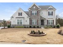 Two story home featuring stone and vinyl siding, complemented by manicured landscaping at 7206 Sumters Camp Trl, Fort Mill, SC 29707