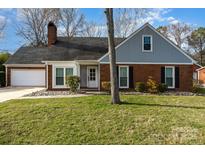 Charming brick home with a well-manicured front yard and attached garage at 7544 Yellow Pine Ct, Charlotte, NC 28277