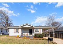 Charming single-story home with a carport, small porch, and manicured front yard at 909 Laye St, Belmont, NC 28012