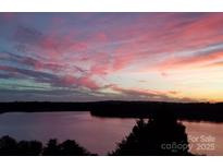 Beautiful sunset view of the lake and clouds at 9709 Emerald Point Dr # 2, Charlotte, NC 28278