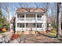 Charming two-story home featuring double balconies, a well-maintained yard, and inviting curb appeal at 11121 Timber Hill Ct, Charlotte, NC 28226