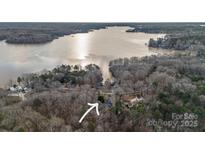 Picturesque aerial view of a home nestled among trees near a tranquil lake at 1665 Sherwood Ct, Sherrills Ford, NC 28673