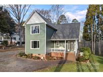 Charming two-story home with a covered front porch and nicely landscaped front yard at 1665 Sherwood Ct, Sherrills Ford, NC 28673