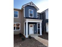 Charming two-story townhome with covered entry, manicured landscaping, and appealing exterior finishes at 330 Malvern Sw Ave # B, Concord, NC 28025