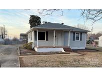 Charming single-story home featuring a covered porch and vinyl siding at 3412 1St Avenue Nw Cir, Hickory, NC 28601
