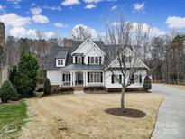 Charming two-story home with a manicured lawn, covered porch, and dark shutters at 411 Belo Ct, Fort Mill, SC 29715